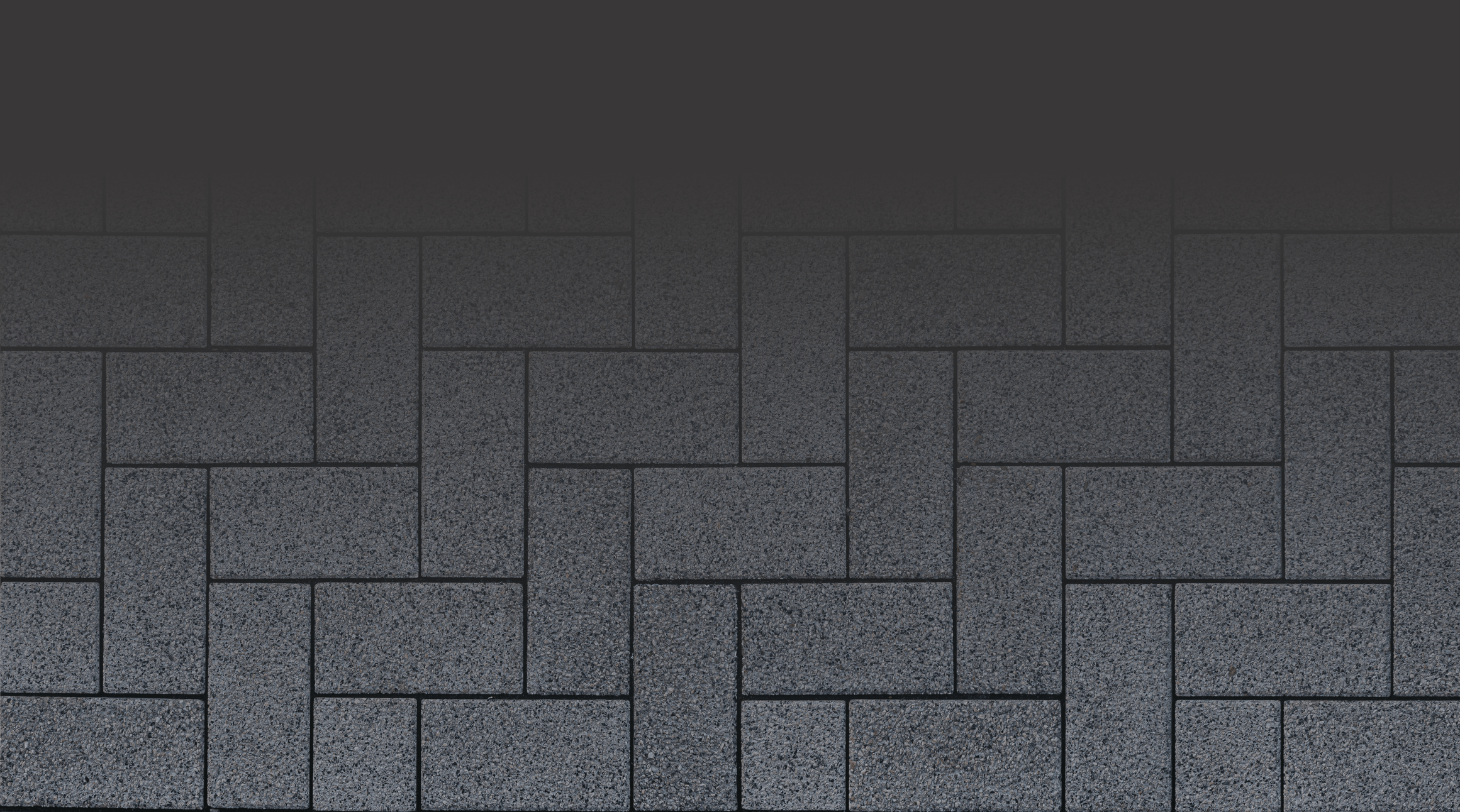 A dark rectangular brick pattern fills the image with a subtle gradient at the top, transitioning into a completely black background.