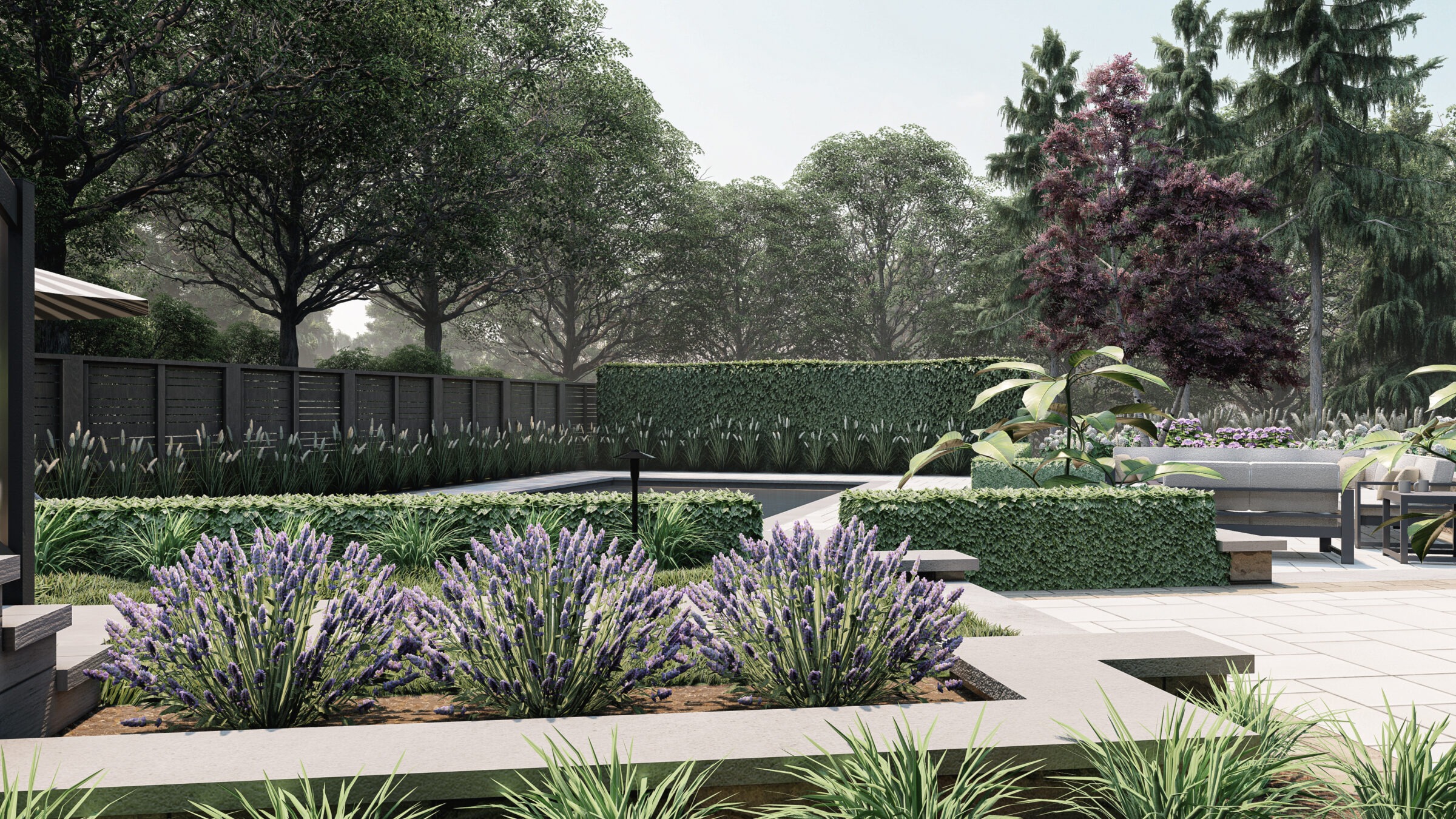 Modern landscaped garden featuring lush greenery, lavender plants, and a sleek patio area. Tall trees provide a serene, natural backdrop.