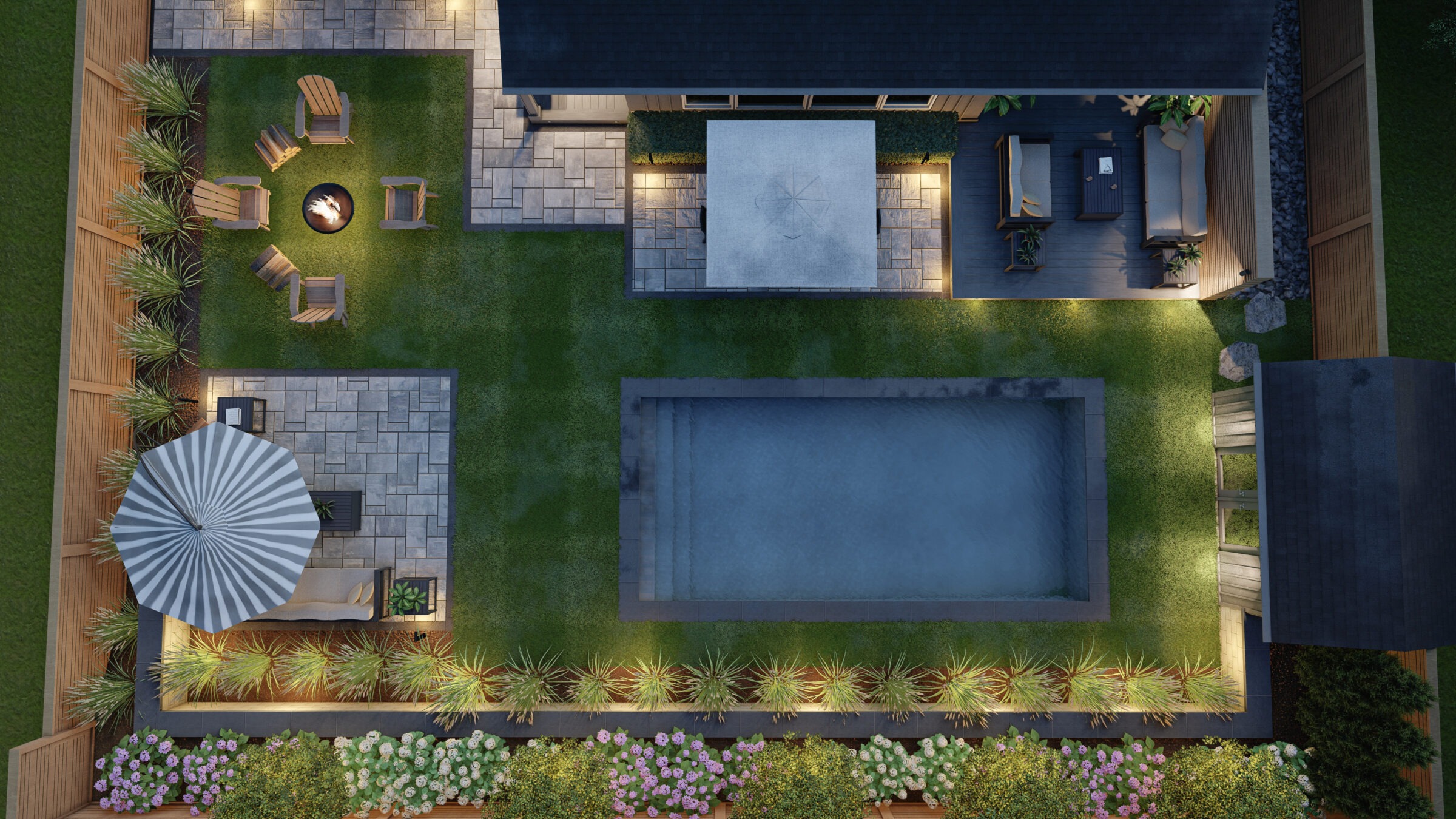 Aerial view of a backyard featuring a pool, patio seating, fire pit, plants, and striped umbrella. Area is beautifully lit in twilight.