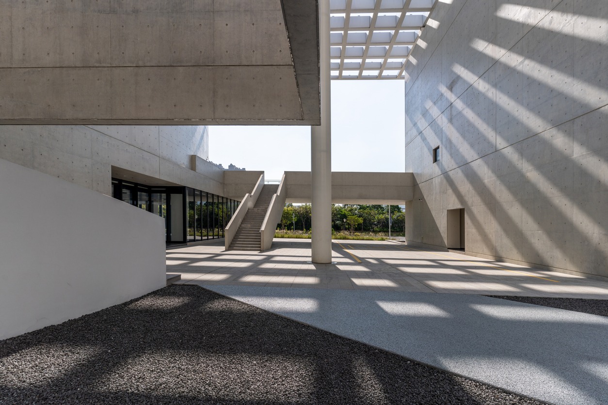 Sunshine leaves light and shadow on cement walls and structures in modern architecture